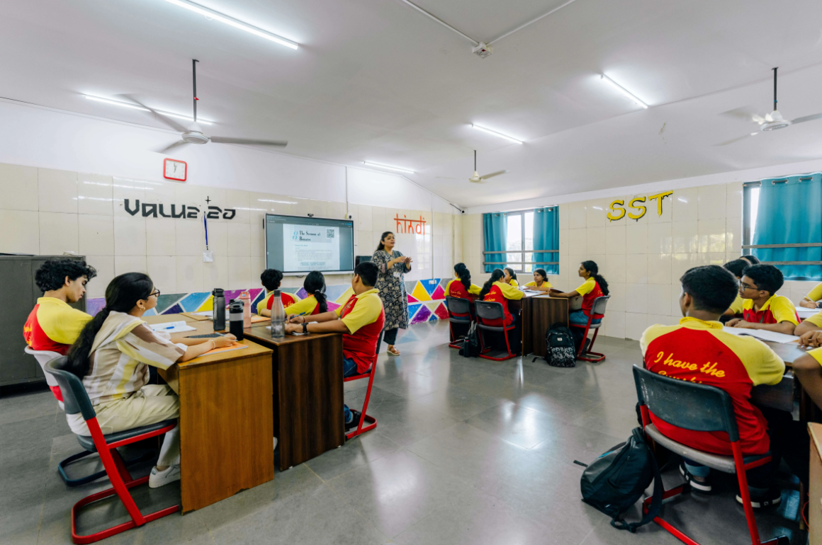 Students in uniform with a teacher in class
