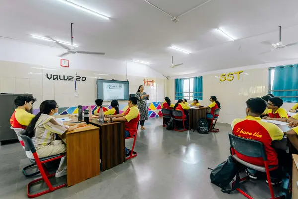 Students in uniform with a teacher in class