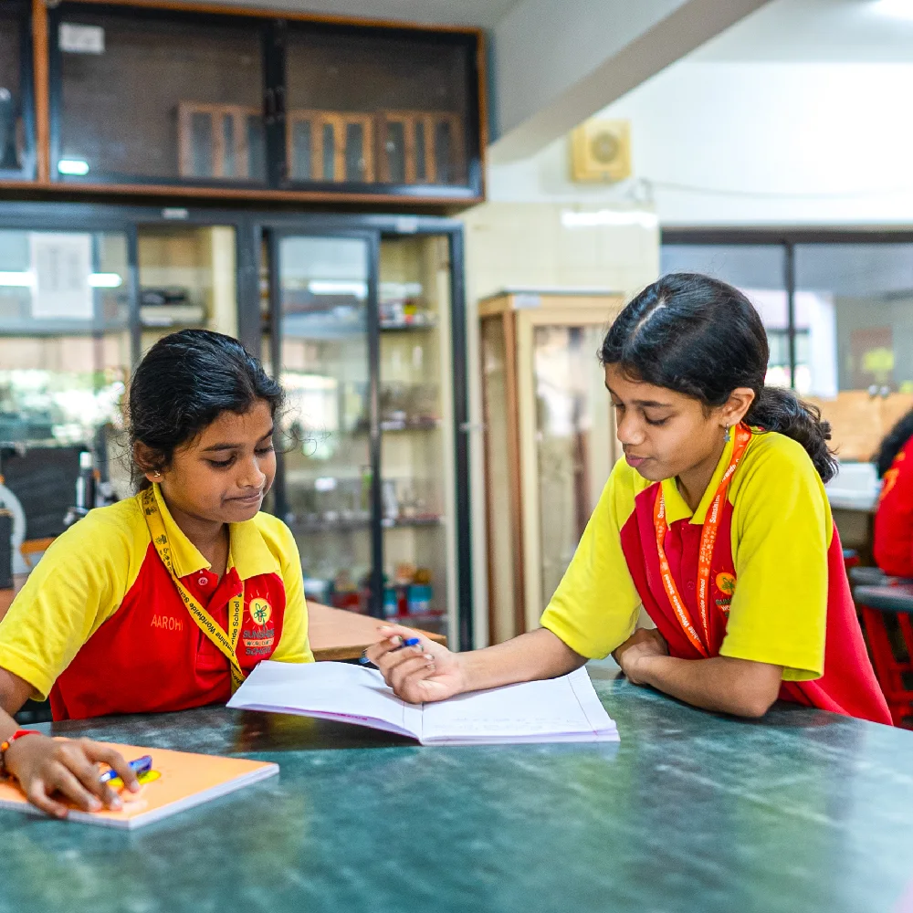 Two students are studying together at a table