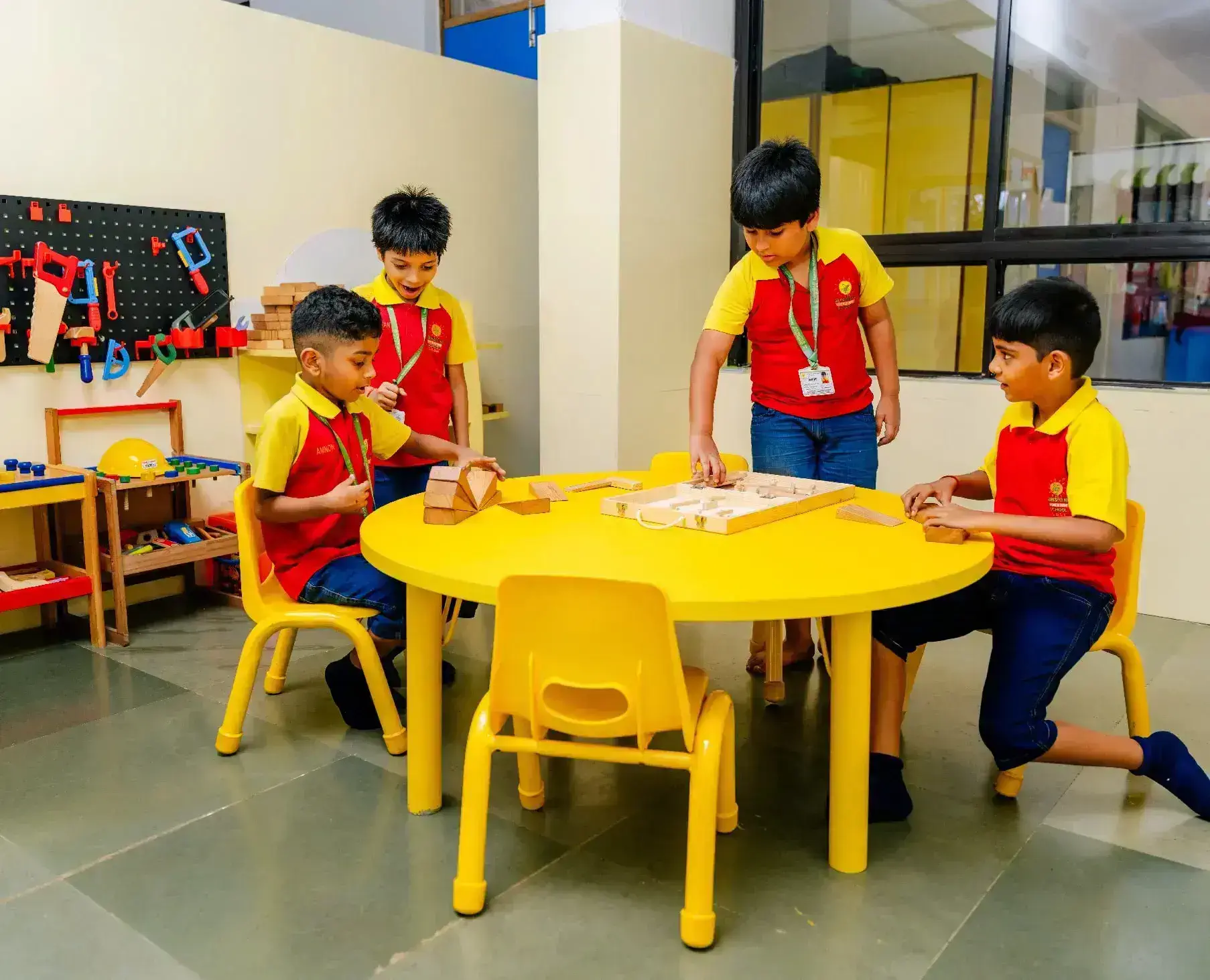 Children building blocks in colorful classroom